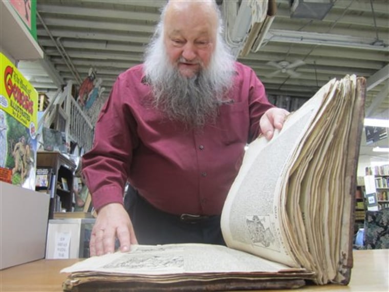 In this photo taken Saturday, April 23, 2011, Utah book dealer Ken Sanders looks over a copy of the Nuremberg Chronicle published in 1493. The book is on display at Ken Sanders Rare Books in Salt Lake City. Sanders across the 500-year-old German language edition while appraising items brought in by locals at a fundraiser for the town museum in Sandy, about 15 miles south of Salt Lake City. It's considered to be one of the earliest and most lavishly illustrated books produced after the invention of the printing press. (AP Photo/Brian Skoloff)